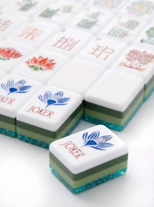 Scattered olive green and white American Mahjong acrylic tiles showing various suits