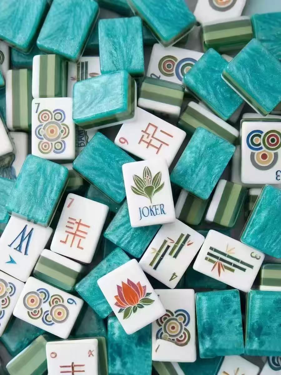 American Mahjong tile rack with olive green acrylic tiles arranged in a row